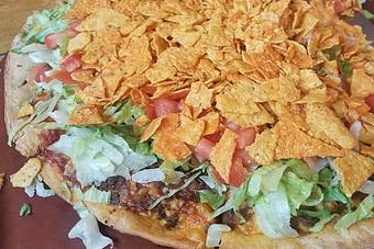 Product: Topped with lettuce, diced tomatoes & taco chips - Moosejaw Pizza in The Waterpark Capital of the World in Wisconsin Dells! - Wisconsin Dells, WI American Restaurants Product: Topped with lettuce, diced tomatoes & taco chips - Moosejaw Pizza in The Waterpark Capital of the World in Wisconsin Dells! - Wisconsin Dells, WI American Restaurants