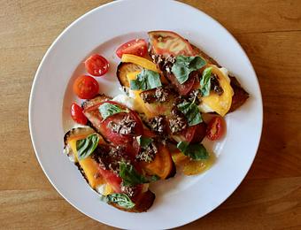 Product: Seasonally inspired menu with daily specials. Pictured: Burrata & Heirloom Tomato Crostini with Olive Tapenade. - Onespeed in Sacramento, CA Pizza Restaurant