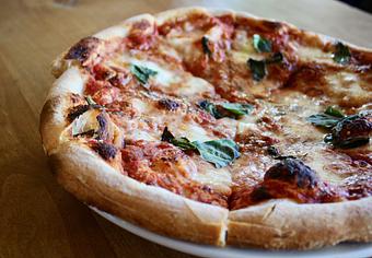 Product: Seasonally inspired menu with daily specials. Pictured: Margherita with Fior di Latte, Tomato Sauce, Basil, Olive Oil - Onespeed in Sacramento, CA Pizza Restaurant
