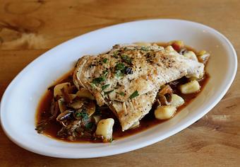 Product: Seasonally inspired menu with daily specials. Pictured: Grilled Mary's Chicken with Potato Gnocchi, Braised Mushrooms, Leeks, Tomato, Marsala Jus - Onespeed in Sacramento, CA Pizza Restaurant