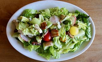 Product: Seasonally inspired menu with daily specials. Pictured: OneSpeed Chopped Salad with Grilled Chicken, Smoked Bacon, Blue Cheese, Avocado, Cucumber, Romaine Lettuce - Onespeed in Sacramento, CA Pizza Restaurant