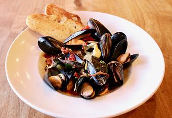 Product: Seasonally inspired menu with daily specials. Pictured: Salt Spring Mussels with Preserved Tomato, Garlic, White Wine, Calabrian Chili, Grilled Focaccia, Aioli - Onespeed in Sacramento, CA Pizza Restaurant