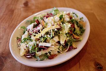 Product: Seasonally inspired menu with daily specials. Pictured: Bitter Greens with Pancetta, Mustard Vinaigrette, Croutons, Sieved Egg - Onespeed in Sacramento, CA Pizza Restaurant