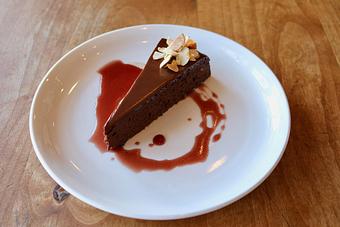 Product: Seasonally inspired menu with daily specials. Pictured: Flourless Chocolate Cake with Red Wine Caramel, Almonds - Onespeed in Sacramento, CA Pizza Restaurant