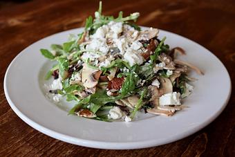 Product: Grilled Radicchio with Shaved Mushrooms, Smoked Prosciutto, Olives, Feta, Arugula, Sherry Vinaigrette - Onespeed in Sacramento, CA Pizza Restaurant