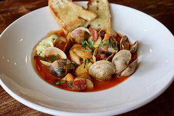 Product: Cod & Clam Stew with Piquillo Pepper Broth, Potatoes, Chorizo, Fennel, Leeks, Aioli, Grilled Focaccia - Onespeed in Sacramento, CA Pizza Restaurant