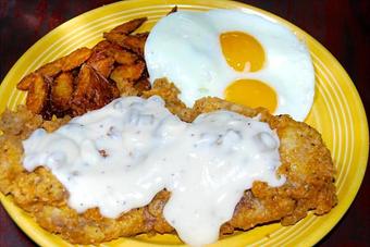 Product: Chicken fried chicken or ribeye with two eggs cooked to order, home fries and toast - Opal Divine’s Austin Grill in Travis Heights/ South Austin - Austin, TX American Restaurants