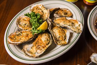 Product: Parmesan Garlic Oysters (8)*, Parmesan Garlic Oysters (8) - Original Oyster House Boardwalk in Gulf Shores, AL Seafood Restaurants