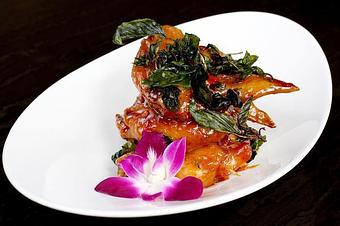 Product: Crispy chicken wings topped with our homemade sauce and crispy basil. - Osha Thai Noodle Cafe in Tenderloin - San Francisco, CA Thai Restaurants Product: Crispy chicken wings topped with our homemade sauce and crispy basil. - Osha Thai Noodle Cafe in Tenderloin - San Francisco, CA Thai Restaurants