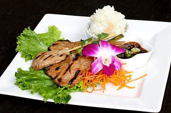 Product: Marinated grilled pork on skewer, pepper, garlic served with tamarind sauce and sticky rice. - Osha Thai Noodle Cafe in Tenderloin - San Francisco, CA Thai Restaurants Product: Marinated grilled pork on skewer, pepper, garlic served with tamarind sauce and sticky rice. - Osha Thai Noodle Cafe in Tenderloin - San Francisco, CA Thai Restaurants