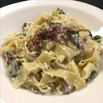 Product: A beautiful blending of flavors…black pepper roasted chicken breast with bacon and swiss chard in a creamy goat milk sauce tossed with house-made pappardelle pasta. - Paesano Restaurant & Wine Bar in Ann Arbor, MI Italian Restaurants