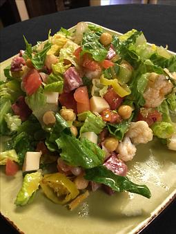 Product: Shredded romaine lettuce with chickpeas, diced tomatoes, Soppressata salami, diced mozzarella cheese, pepperoncini peppers, roasted cauliflower and red-wine vinaigrette. - Paesano Restaurant & Wine Bar in Ann Arbor, MI Italian Restaurants