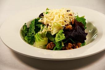 Product: Mixed greens topped with fontina cheese, roasted walnuts and mixed raisins with a honey balsamic dressing - Pasta D'arte Trattoria Italiana in Chicago, IL Italian Restaurants