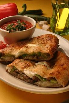 Product: This is a picture of our veggie calzone. - Potomac Village Deli in Kentlands - Gaithersburg, MD American Restaurants