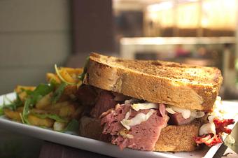 Product: Roasted Corned Beef piled on griddle toasted rye, dressed with a 2000 Island sauce,  housemade kraut, & Emmenthaler Swiss. Served with House Fries. - PUBlic House in Old Town Temecula - Temecula, CA American Restaurants
