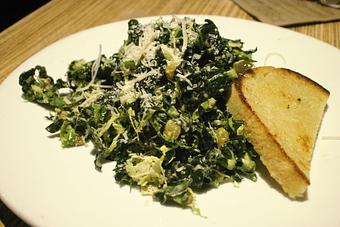 Product: KALE AND SHAVED BRUSSELS SPROUTS TOSSED WITH A GARLIC ANCHOVY CAESAR, GOLDEN RAISINS AND GRANA PADANO SERVED W/ GRILLED SOUR DOUGH. - PUBlic House in Old Town Temecula - Temecula, CA American Restaurants