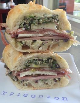 Product: salami, italian ham, prosciutto, provolone, brie, parmesan, olive oil, garlic mayo, arugula and olive tapenade on crusty baguette - Purple Onion Cafe in Downtown Los Gatos - Los Gatos, CA American Restaurants