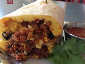 Product: scrambled eggs, potato, black beans, blistered corn, cheddar, spicy crema, flour tortilla and choice of roasted vegetable or chorizo - Purple Onion Cafe in Downtown Los Gatos - Los Gatos, CA American Restaurants