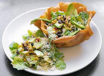 Product: Crispy tortilla bowl, romaine lettuce, black bean-corn salsa, avocado, queso fresco, chipotle Caesar dressing. - Red Mesa Restaurant in St Petersburg, FL Mexican Restaurants
