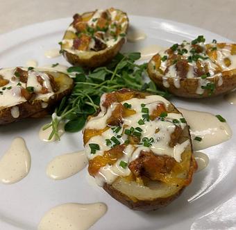 Product: smoked beef brisket, sharp cheddar cheese, and green onions, white BBQ sauce - Red Rocker Inn in Black Mountain, NC American Restaurants