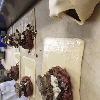 Product: Making a lamb burger Wellington w/lamb liver pate & feta cheese. - Relish in Grinnell, IA American Restaurants