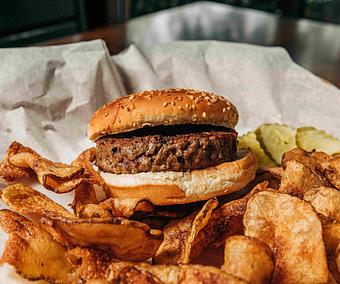 Product: Plain hamburger on a potato bun served with potato chips and sliced pickles - RJ Grunts in Lincoln Park - Chicago, IL American Restaurants