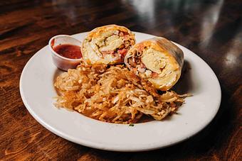 Product: a sliced breakfast burrito wrapped in a tortilla served with sliced hashbrowns on the side - RJ Grunts in Lincoln Park - Chicago, IL American Restaurants