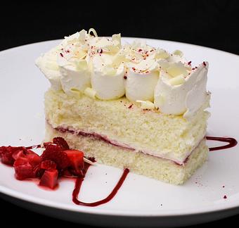Product: Our Famous White Chocolate Mousse Cake - Salty's on Alki in Alki Beach, West Seattle - Seattle, WA American Restaurants