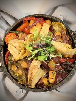 Product: Roasted Local Vegetables, Arugula and an Herb Tomato Broth over Cheesy Sprouted GF Grits - Savour in Tallahassee, FL American Restaurants