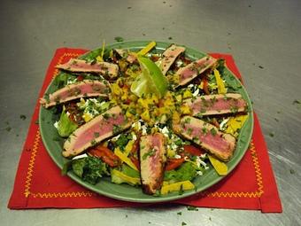 Product: Yellow Fin Tuna is rubbed with spices, seared rare, sliced, and served over mixed greens tossed in Balsamic Vinaigrette, and topped with Cojita cheese, black bean corn salsa, roasted red peppers, pineapple mango salsa, and friend corn tortilla strips. - Shorty's Mexican Roadhouse in Nashua, NH Mexican Restaurants