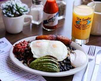 Product: A little southern hemisphere influence with eggs done your way served with black beans (best anywhere), fresh avocado and slimsalsa, sour cream and our popular fried plantains. - Slim Goodies Diner in New Orleans, LA Vegetarian Restaurants