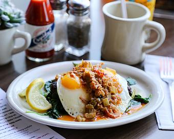 Product: A little ditty that mixes New York with New Orleans, two potato latkes topped with fresh grilled spinach, two eggs your way and slims Crawfish Etoufee, just like Rose used to make it - Slim Goodies Diner in New Orleans, LA Vegetarian Restaurants
