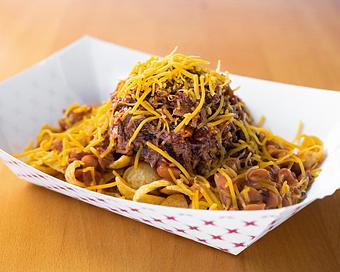 Product: Frito Pie with Frito Corn Chips, Pinto Beans, Chop and Cheddar Cheese - Smokey Mo's BBQ in San Antonio, TX Barbecue Restaurants