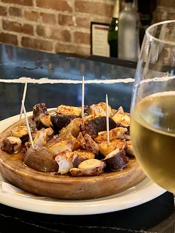 Product: galician style sliced octopus, potato cubes, paprika oil, sea salt - Socarrat Paella Bar - Chelsea in Chelsea - New York, NY Spanish Restaurants