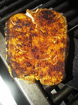 Product: Thick-cut Halibut steaks, delivered fresh daily, seared on cast-iron and served with Risi e Bisi, lemon vinaigrette and microgreens - Stellina in Watertown, MA Italian Restaurants