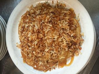 Product: In honor of the Girl Scouts of America - Samoa Pancakes - Pancakes with chocolate chips topped with toasted coconut and drizzled with caramel sauce - Sunflower Cafe in Charleston, SC American Restaurants Product: In honor of the Girl Scouts of America - Samoa Pancakes - Pancakes with chocolate chips topped with toasted coconut and drizzled with caramel sauce - Sunflower Cafe in Charleston, SC American Restaurants