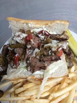 Product: Philly - Filet mignon, peppers, onions, Boar's Head baby swiss cheese, lettuce, tomato, and mayonnaise on toasted french bread - Sunflower Cafe in Charleston, SC American Restaurants Product: Philly - Filet mignon, peppers, onions, Boar's Head baby swiss cheese, lettuce, tomato, and mayonnaise on toasted french bread - Sunflower Cafe in Charleston, SC American Restaurants