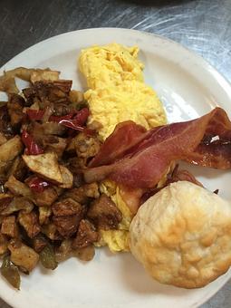Product: Two egg breakfast served with bacon or sausage, grits or potatoes, and biscuit - Sunflower Cafe in Charleston, SC American Restaurants Product: Two egg breakfast served with bacon or sausage, grits or potatoes, and biscuit - Sunflower Cafe in Charleston, SC American Restaurants