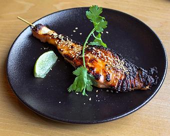 Product: faroe island salmon is marinated with sake, miso and mirin, skewered and grilled over binchotan charcoal. finished with sesame seeds and lime. - Sushi San - Reservations in River North - Chicago, IL Japanese Restaurants