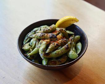 Product: whole edamame pods are tossed in garlic oil and roasted in our coal-burning oven before being finished with a squeeze of lemon and a dusting of our signature S+P seasoning - Sushi San - Reservations in River North - Chicago, IL Japanese Restaurants