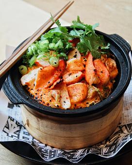 Product: succulent lobster claw and tail is coal-roasted in a cast-iron bowl atop spicy massago mayo and sushi rice. finished with kimchi, green onion and black sesame seeds - Sushi San - Reservations in River North - Chicago, IL Japanese Restaurants