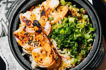Product: jumbo shrimp and chopped shishito peppers are tossed in garlic-miso mayo and coal-roasted in a cast iron bowl atop sushi rice. finished with black sesame seeds and green onion. - Sushi San - Reservations in River North - Chicago, IL Japanese Restaurants