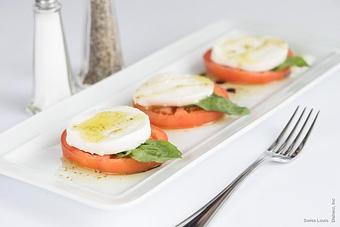 Product: Slices of tomatoes with mozzarella cheese and fresh basil, drizzled with extra virgin olive oil & balsamic vinegar. - Swiss Louis in San Francisco, CA Restaurants/Food & Dining
