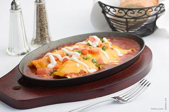 Product: Two flour tortillas filled with crab meat & shredded cheddar cheese then baked in our house-made red enchilada sauce & topped with sour cream & green onions. - Swiss Louis in San Francisco, CA Restaurants/Food & Dining