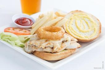 Product: Marinated chicken breast and honey mustard topped with jack cheese and an onion ring served on an artisan bread, served with french fries. - Swiss Louis in San Francisco, CA Restaurants/Food & Dining