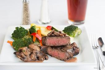 Product: Broiled New York steak, topped with madera mushroom sauce served with sautéed vegetables. - Swiss Louis in San Francisco, CA Restaurants/Food & Dining