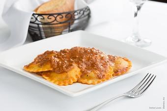 Product: Ravioli filled with beef, served in a meat sauce. - Swiss Louis in San Francisco, CA Restaurants/Food & Dining