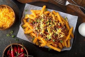 Product: Spicy Loaded Fries - Slow roasted chicken marinated in salsa Verde topped with Pico de Gallo, sour cream, queso fresco and smoked cheddar over crispy seasoned fries - Level 9 Rooftop Bar in East Village - San Diego, CA American Restaurants