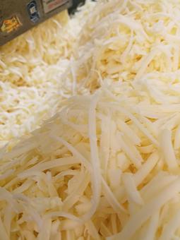 Product: Here we have some cheese being grated to get ready to drizzle on many of our meals. We also melt this cheese on top of our nachos. We do not use pre-grated cheese because it does not have the same fresh taste we look for. - Taqueria Los Gordos in Redding, CA Mexican Restaurants