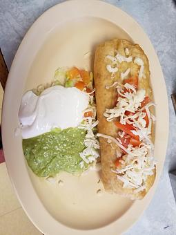 Product: Inside of this deep fried goodness you will find: refried beans, melted Monterey Jack cheese and whatever meat you desire. You can top it with the sour cream and guacamole it comes with. - Taqueria Los Gordos in Redding, CA Mexican Restaurants